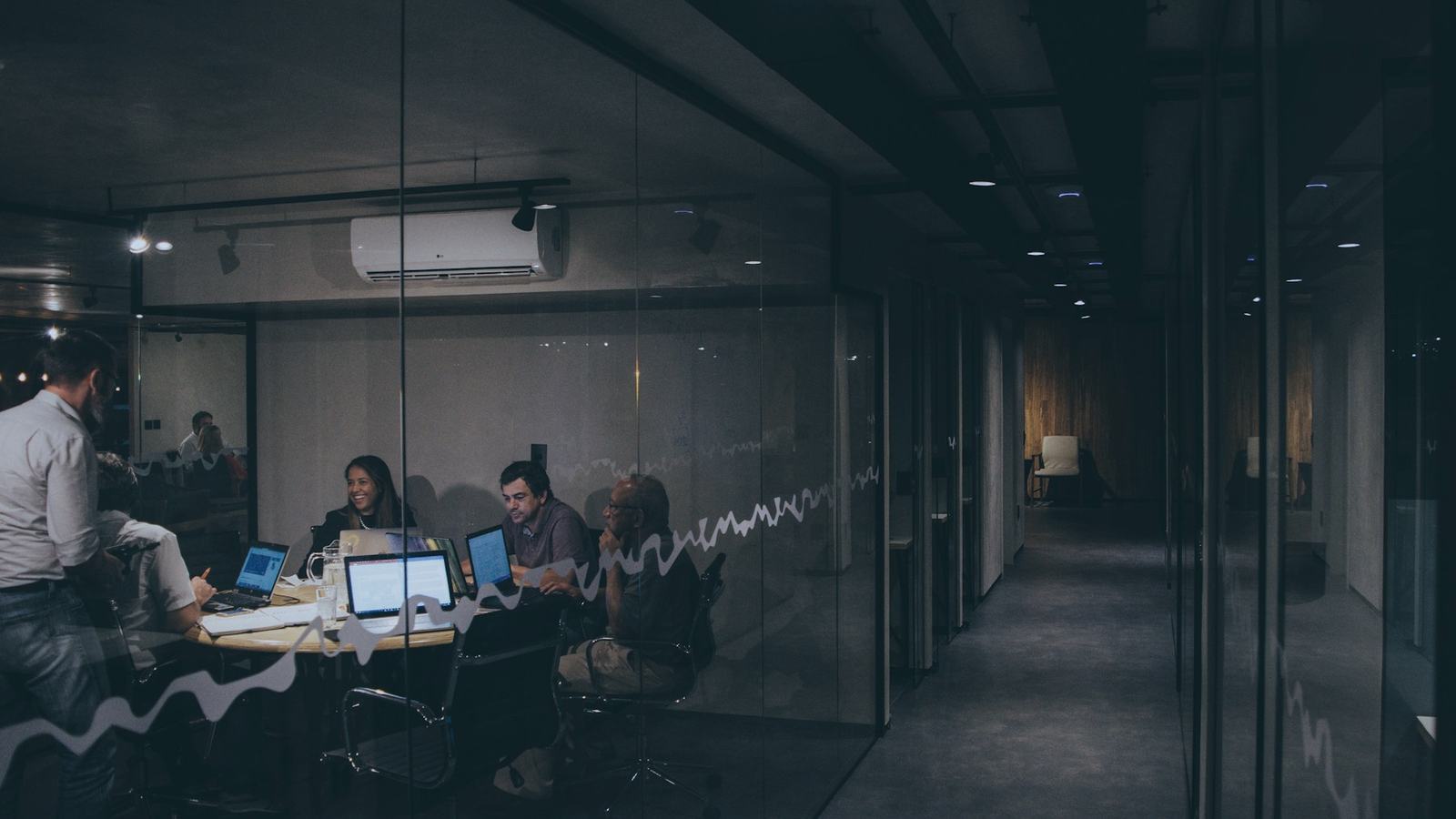 A team meeting in a glass-walled room